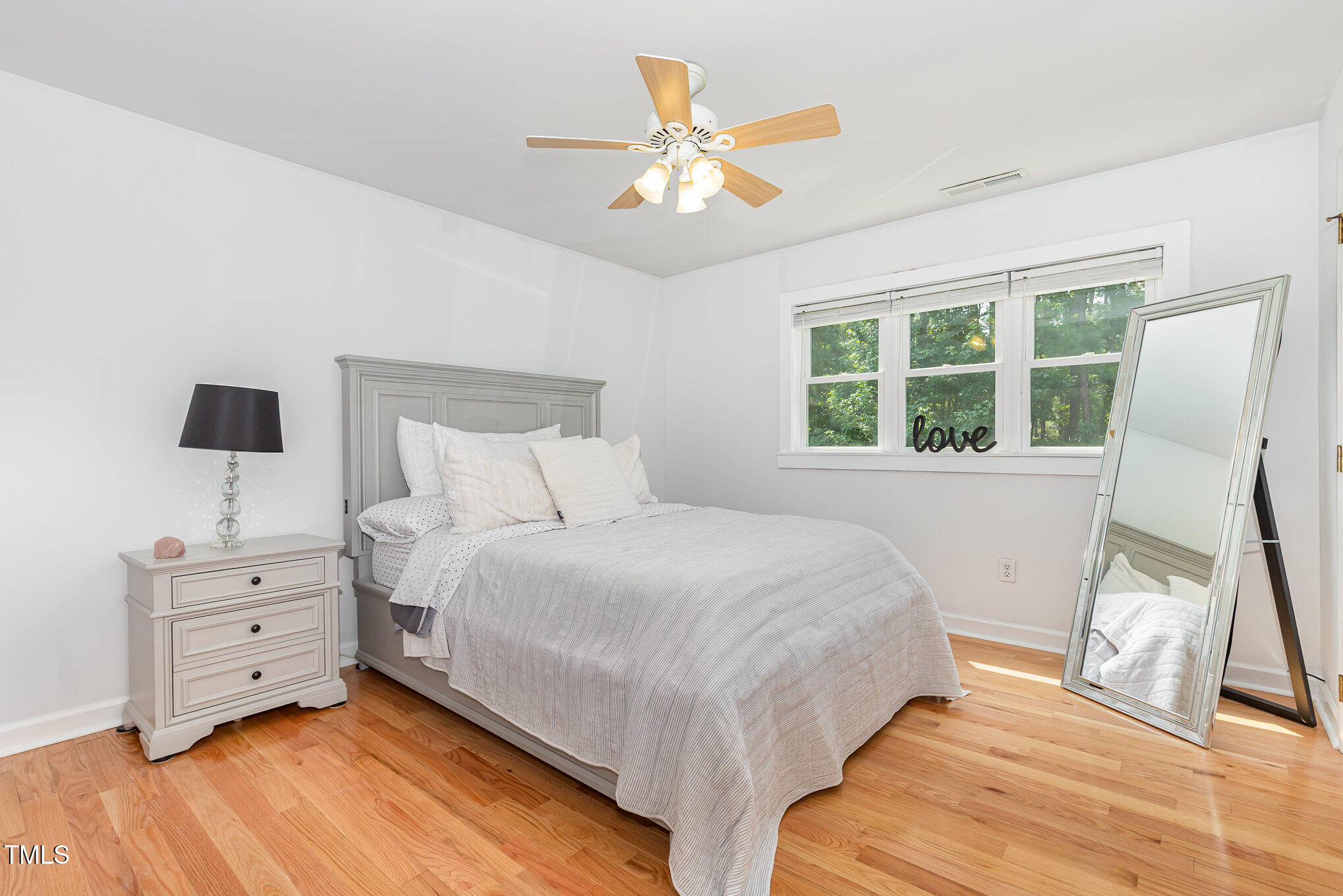 255 Morris Road Pittsboro, NC 27312 - Photo 23 of 40 a bedroom with a bed and a large window