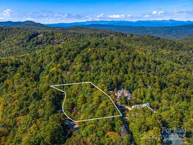 a view of a lush green hillside and houses