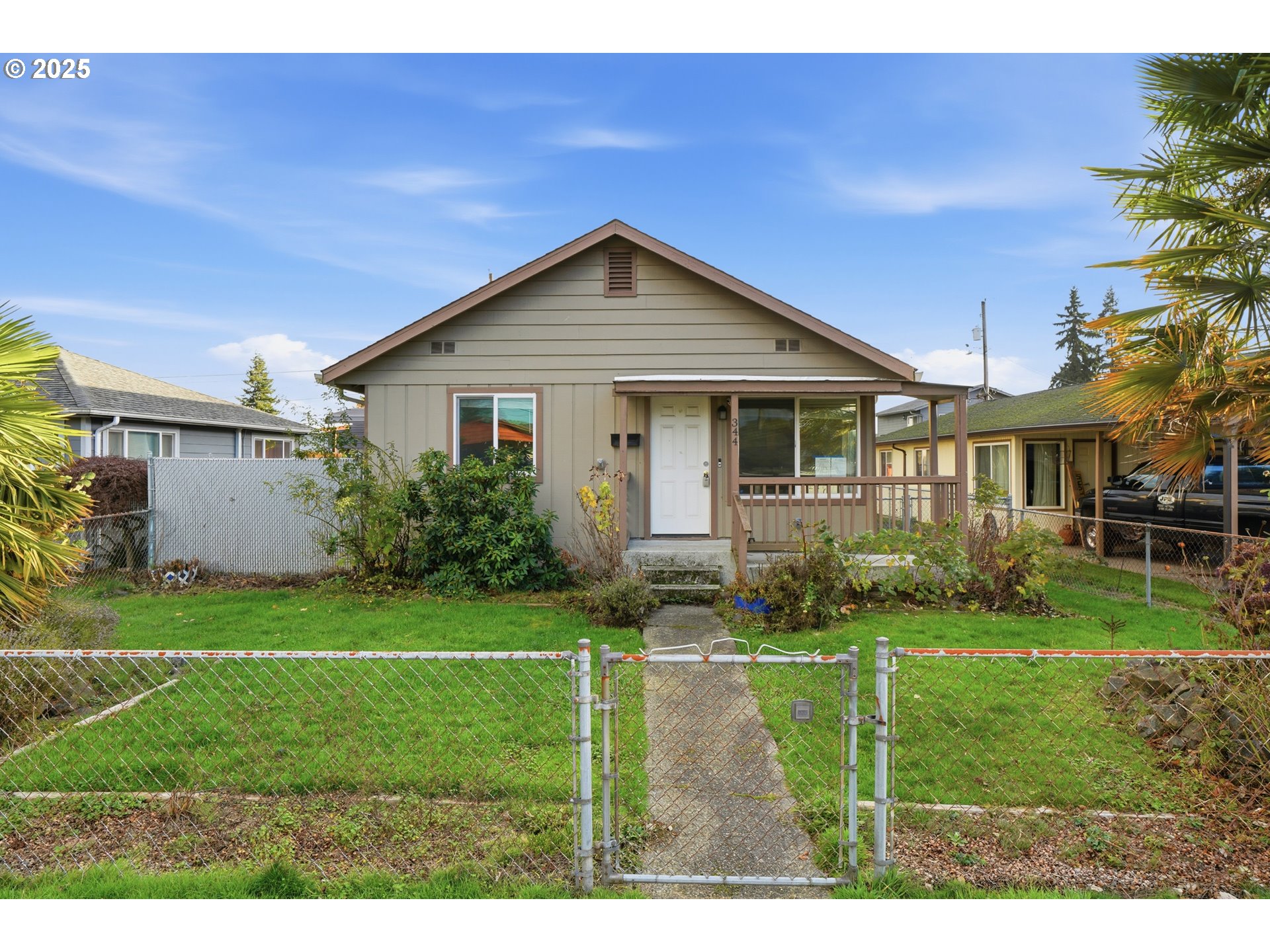 344 Douglas Street Longview, WA 98632 - Photo 4 of 29 a view of a house with a big yard potted plants and large trees