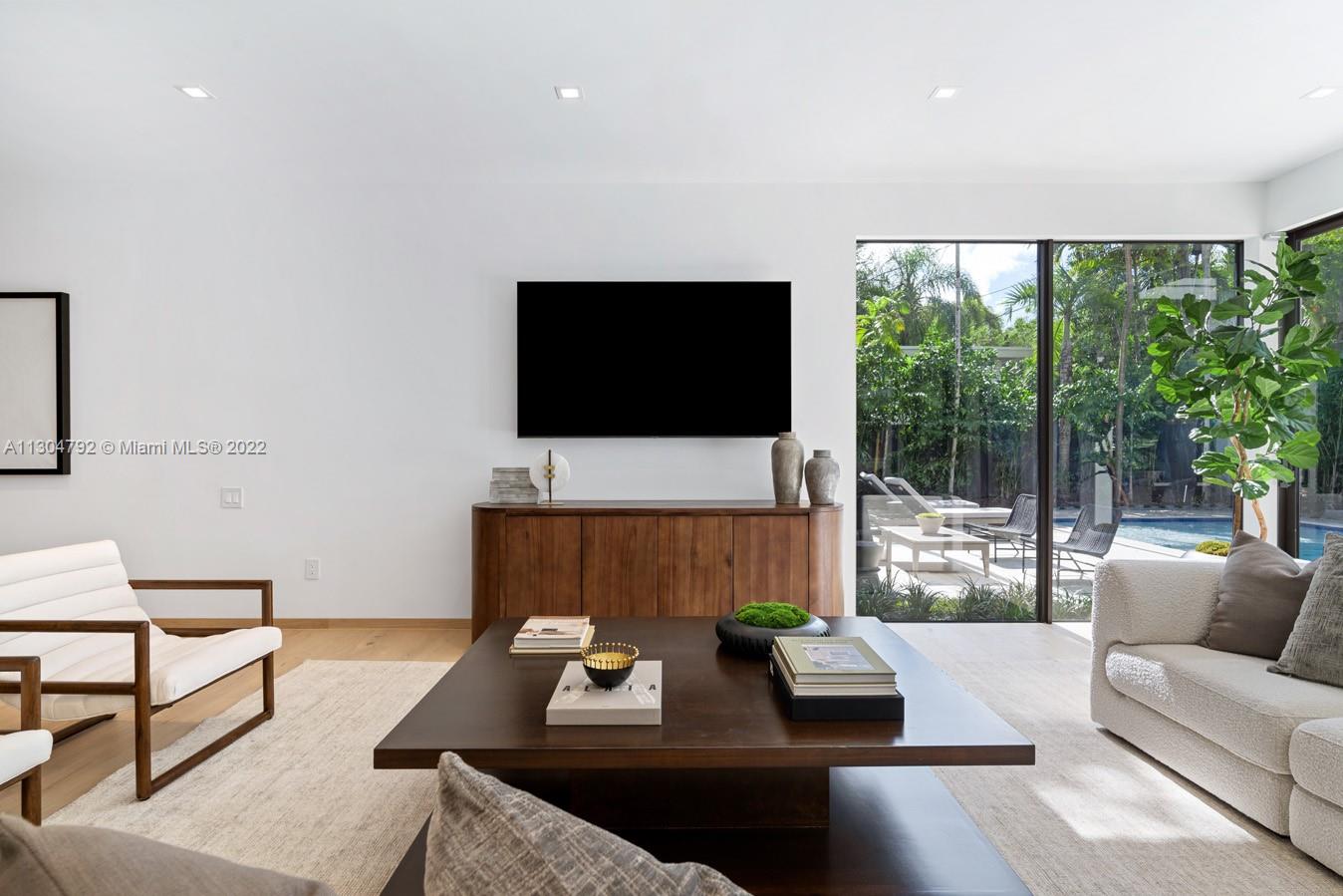 10 Pinta Road Miami, FL 33133 - Photo 15 of 52 a living room with furniture and a flat screen tv