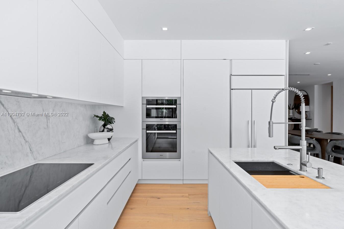 10 Pinta Road Miami, FL 33133 - Photo 21 of 52 a kitchen with stainless steel appliances granite countertop a sink and a refrigerator