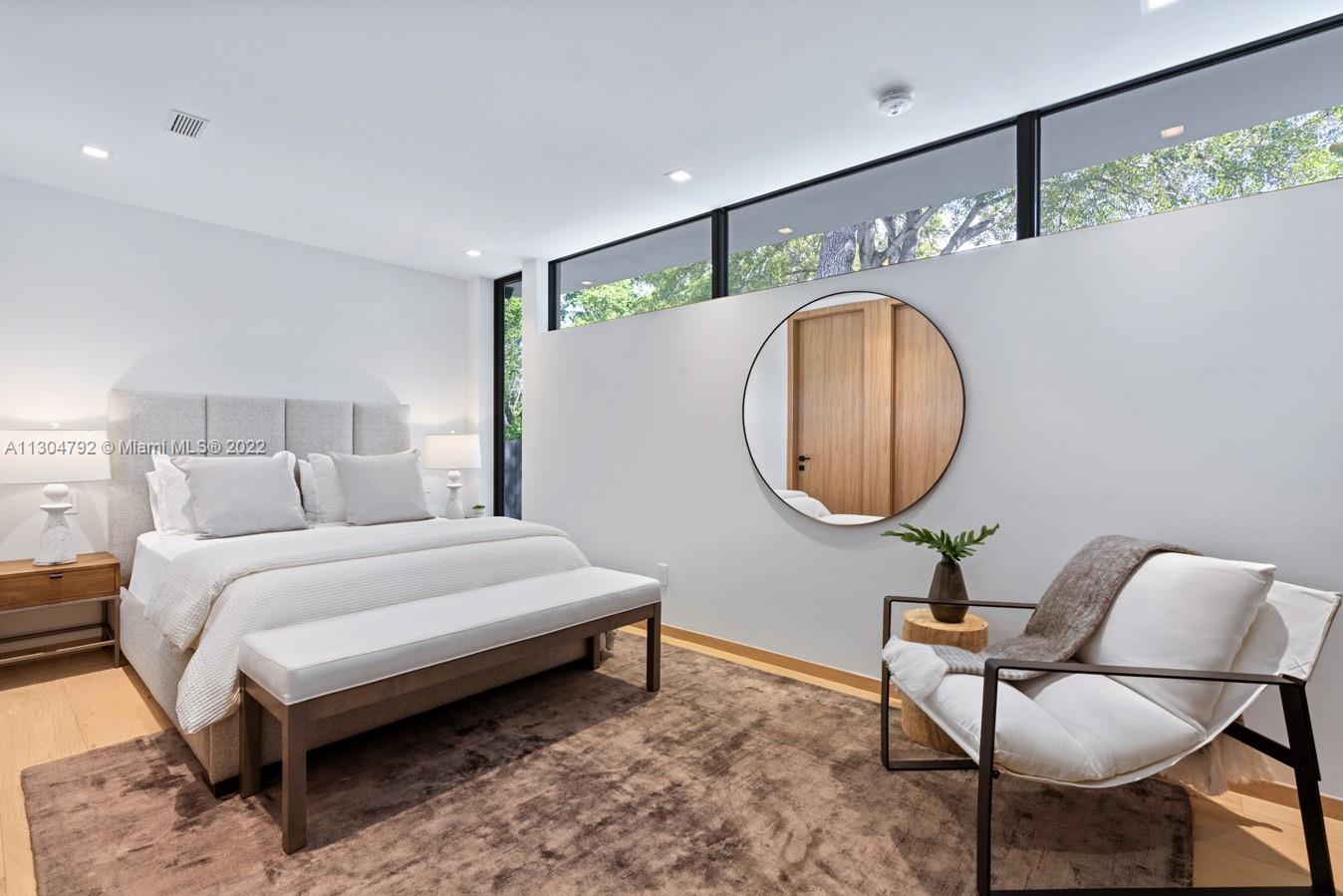 10 Pinta Road Miami, FL 33133 - Photo 23 of 52 a bedroom with a bed a mirror and a table