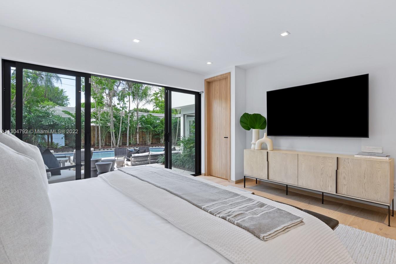 10 Pinta Road Miami, FL 33133 - Photo 27 of 52 a bedroom with a large bed and a flat screen tv