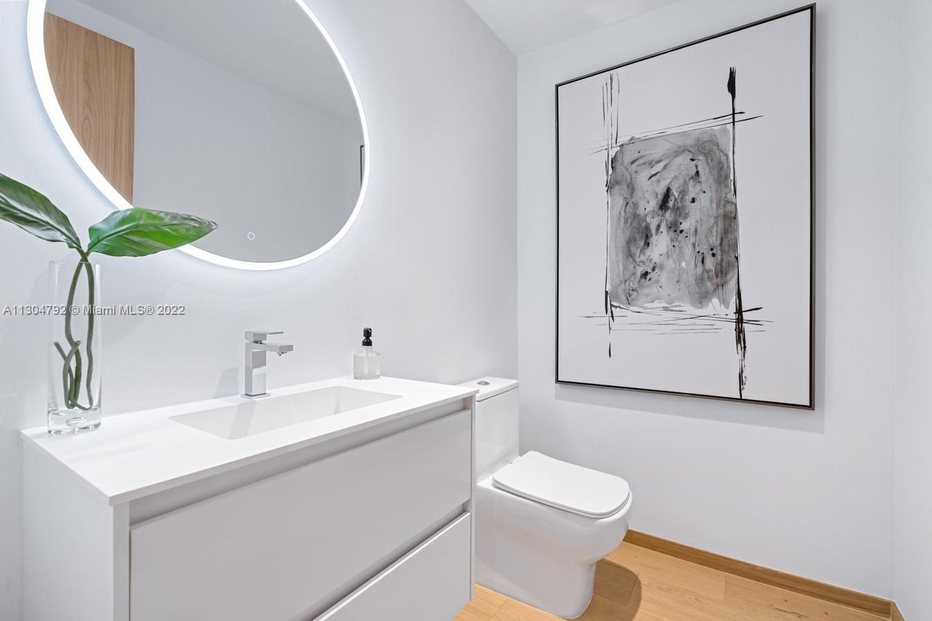 10 Pinta Road Miami, FL 33133 - Photo 32 of 52 a bathroom with a sink and a mirror