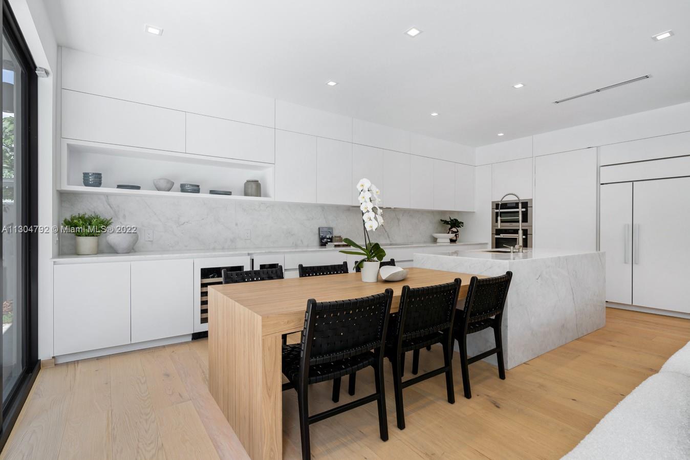 10 Pinta Road Miami, FL 33133 - Photo 42 of 52 a kitchen with a table and chairs in it