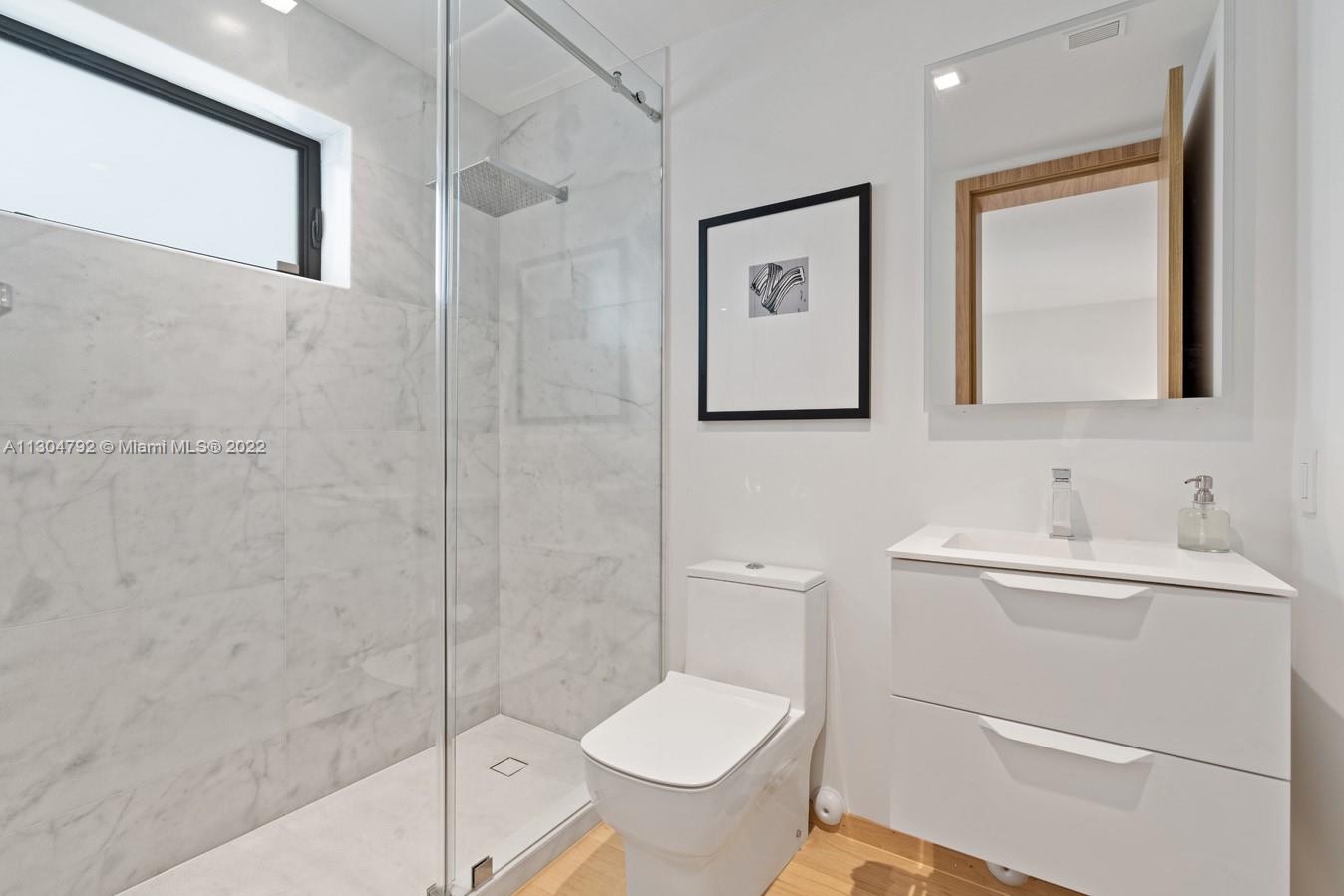 10 Pinta Road Miami, FL 33133 - Photo 45 of 52 a bathroom with a toilet sink and shower