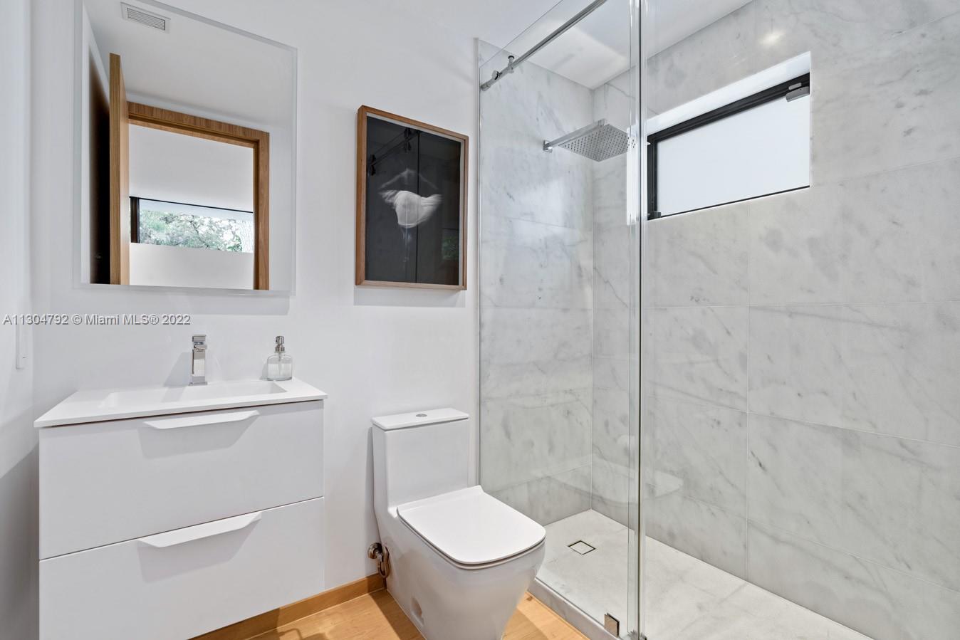 10 Pinta Road Miami, FL 33133 - Photo 47 of 52 a bathroom with a toilet sink and mirror