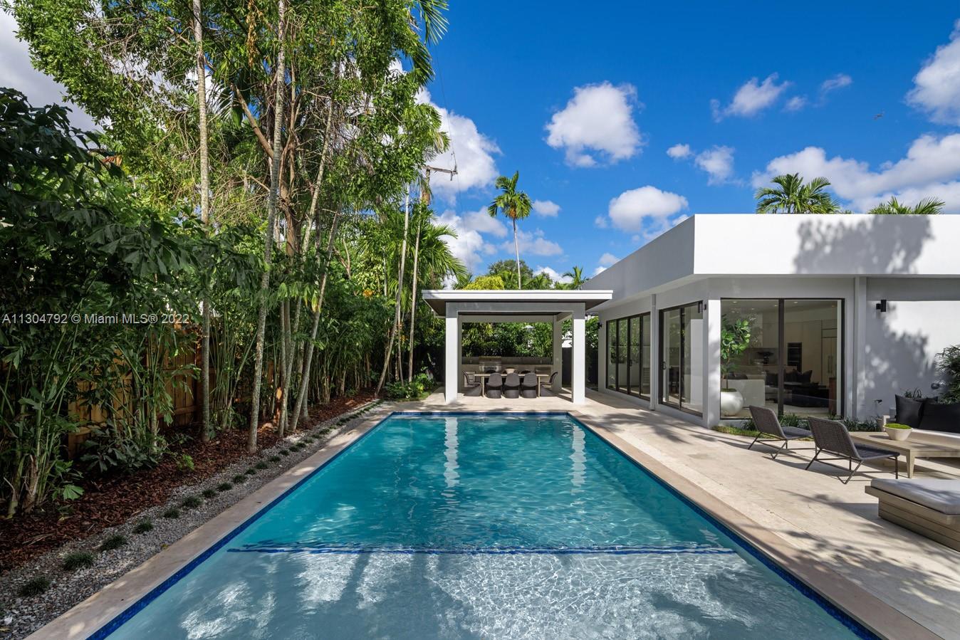 10 Pinta Road Miami, FL 33133 - Photo 6 of 52 a view of a house with backyard outdoor seating and hardwood