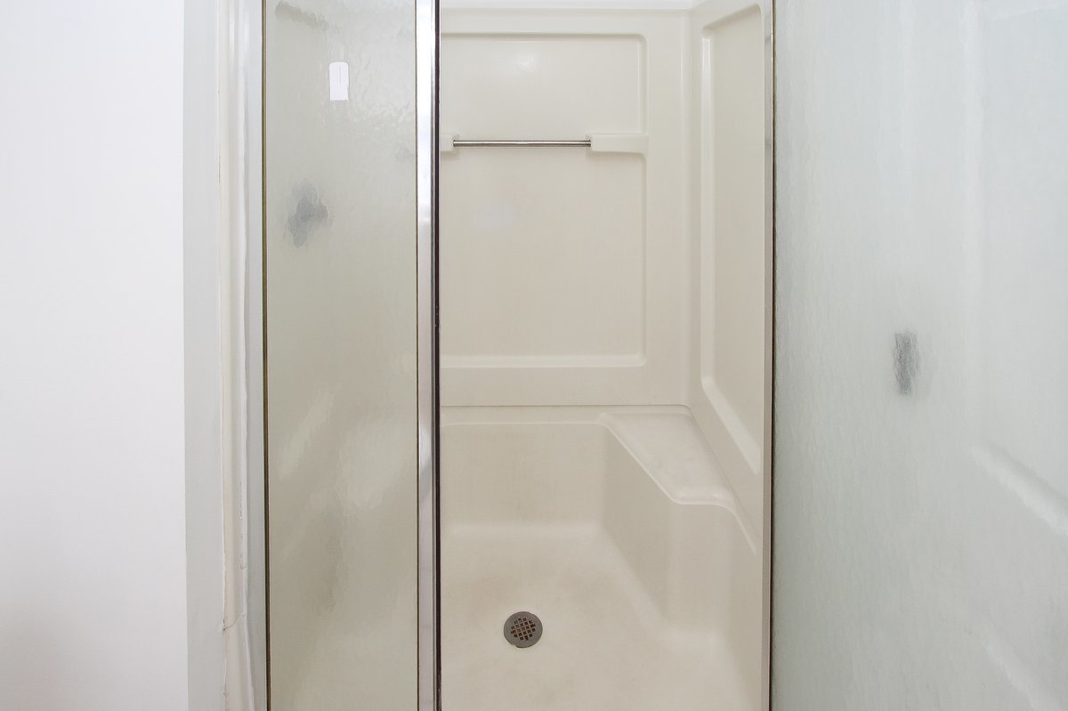 400 Woodview Circle, Unit A Elgin, IL 60120 - Photo 23 of 40 a bathroom with a glass shower door
