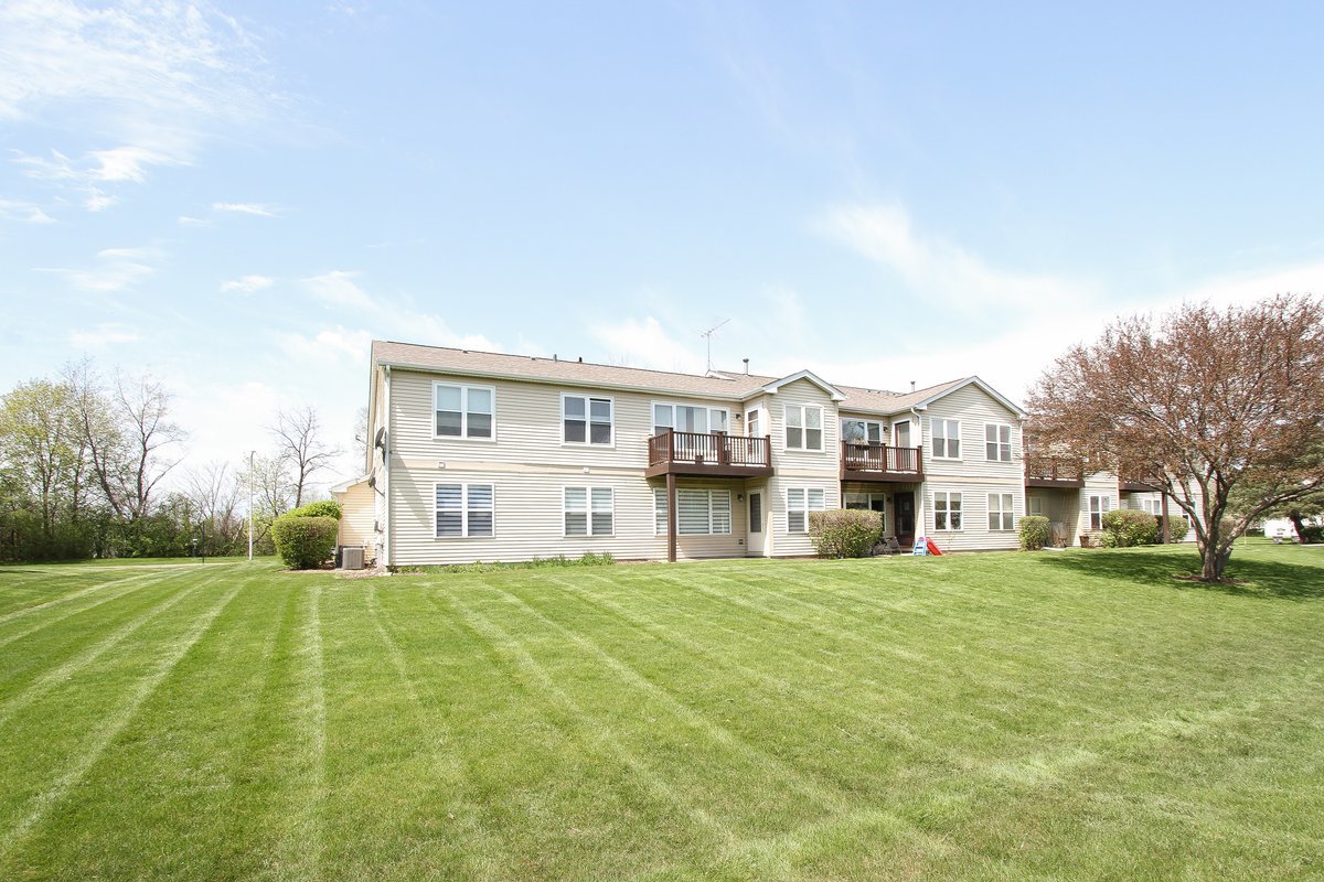 400 Woodview Circle, Unit A Elgin, IL 60120 - Photo 33 of 40 a view of a house with a big yard and large trees