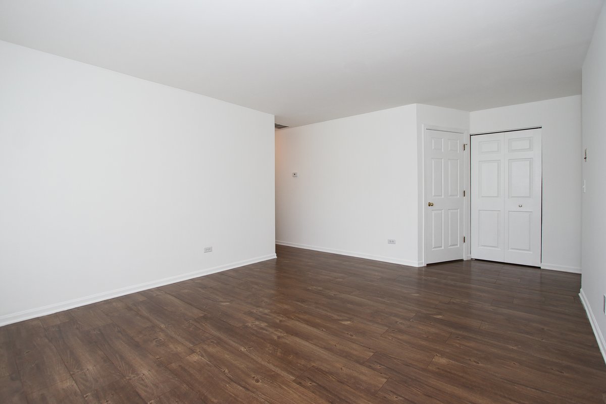 400 Woodview Circle, Unit A Elgin, IL 60120 - Photo 7 of 40 a view of an empty room with wooden floor
