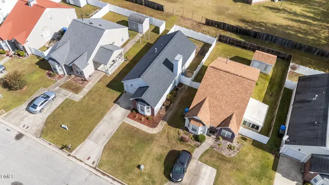 an aerial view of residential house with outdoor space and parking