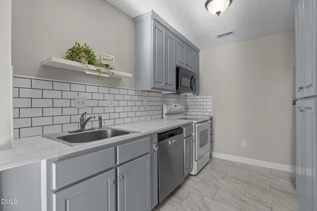 a kitchen with a sink and cabinets