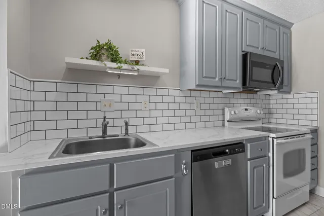 a kitchen with a sink stove and cabinets