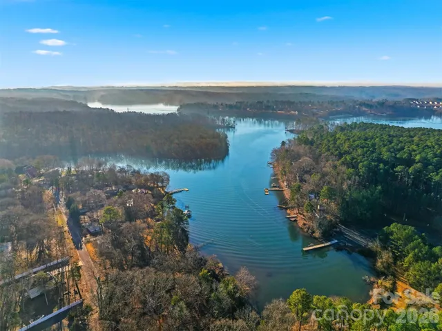 an aerial view of lake and residential houses with outdoor space