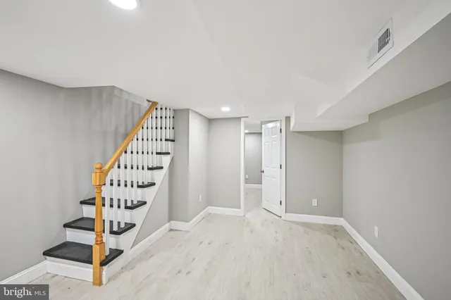 a view of an entryway with wooden floor and door