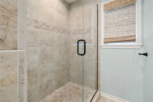a bathroom with a glass shower door