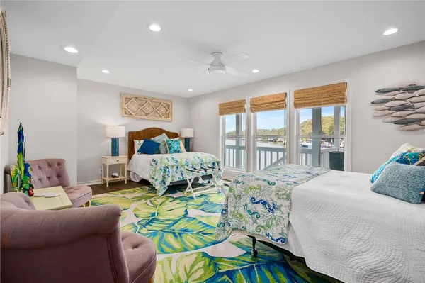a bedroom with a bed and glass windows