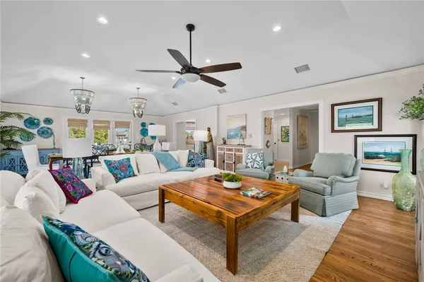 a living room with furniture a rug and a chandelier