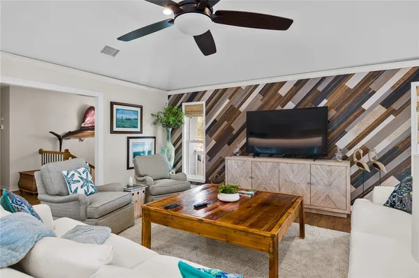 a living room with furniture and a flat screen tv