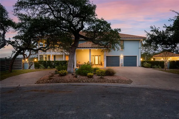 a front view of a house with garden and parking