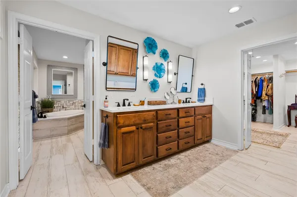a spacious bathroom with a double vanity sink and a mirror