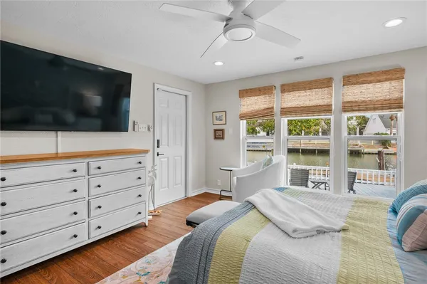 a bedroom with a large bed and a flat screen tv