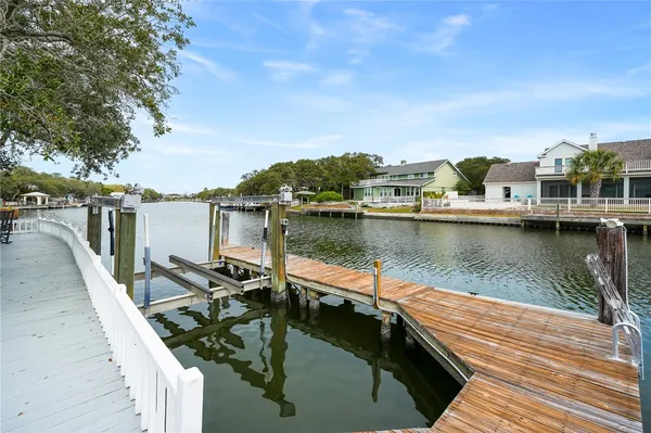 a view of a lake with a table and chairs