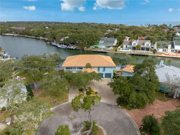 an aerial view of residential houses with outdoor space and lake view