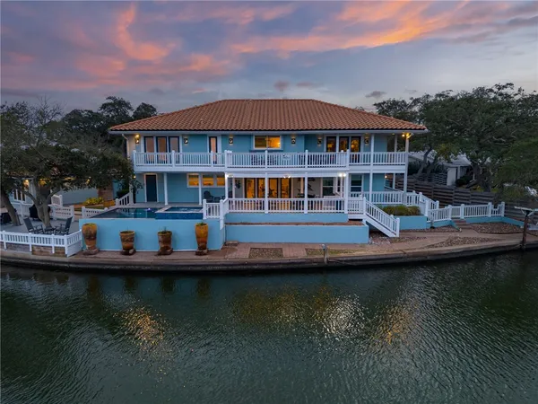 a view of house with swimming pool yard and outdoor seating