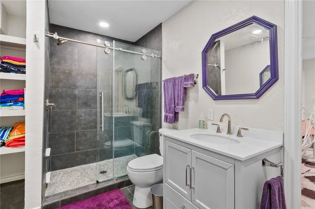 a bathroom with a sink toilet and shower