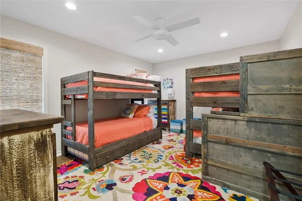 a bedroom with furniture and a flat screen tv