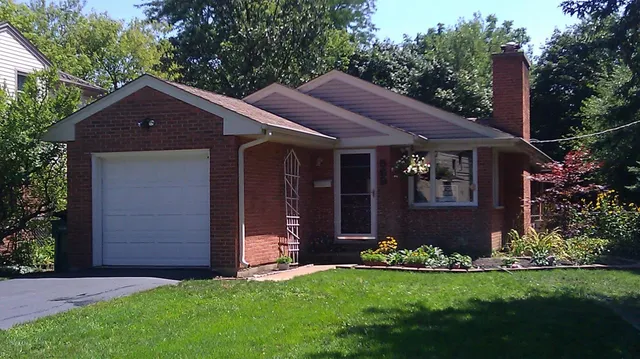 a front view of house with a garden
