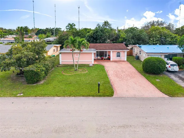 a green field with some trees in the background