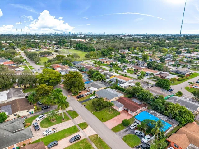 an aerial view of residential houses with outdoor space