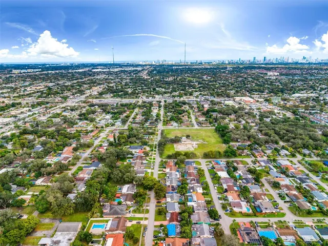 an aerial view of residential houses with city view