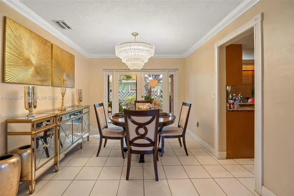 a view of a dining room with furniture and chandelier