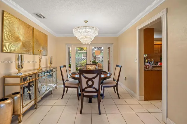 a view of a dining room with furniture and chandelier
