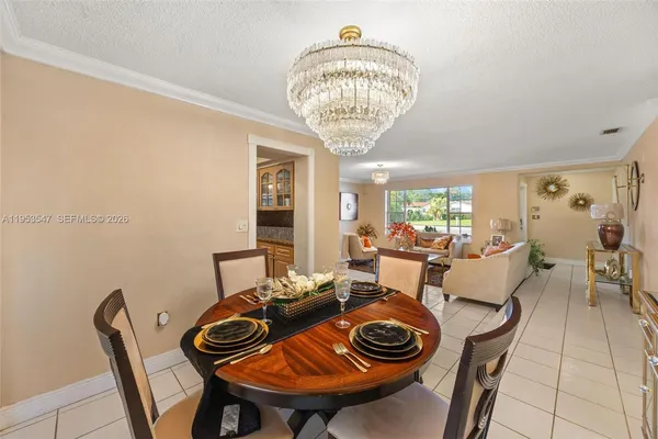 a view of a dining room with furniture and chandelier
