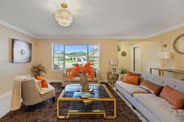 a living room with furniture ceiling fan and a window