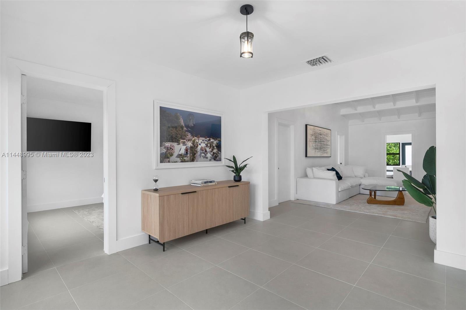 8844 Abbott Avenue Surfside, FL 33154 - Photo 2 of 11 a living room with furniture and a flat screen tv
