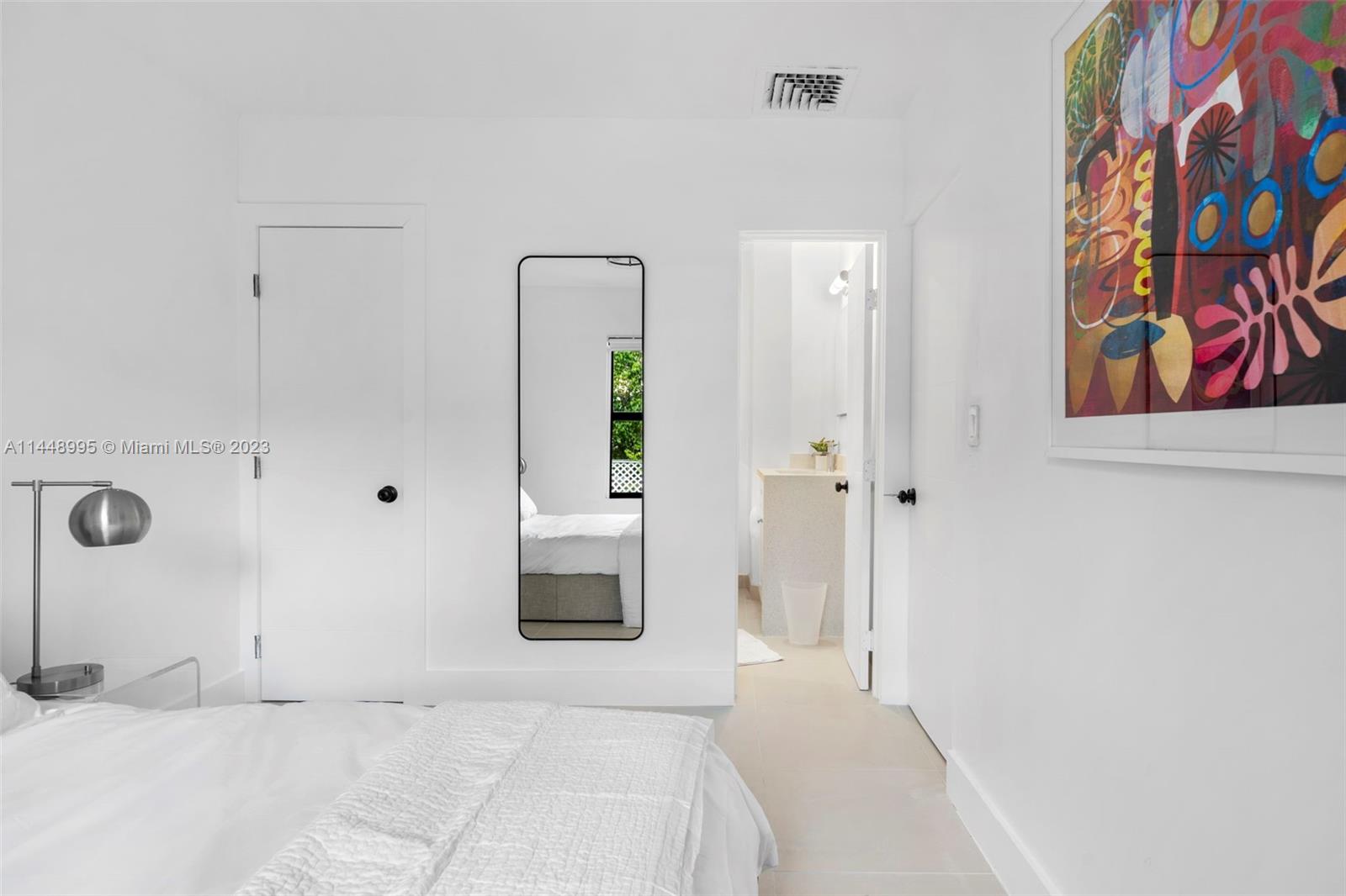 8844 Abbott Avenue Surfside, FL 33154 - Photo 6 of 11 a bedroom with a bed and a painting on the wall