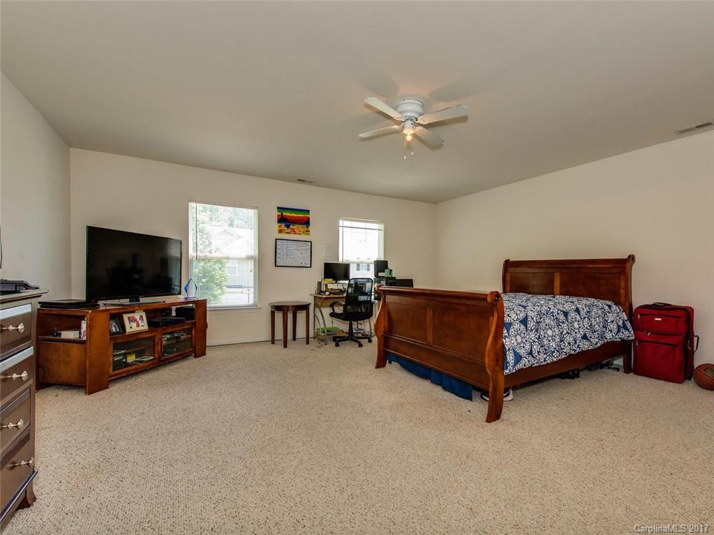 932 Garrison Road Charlotte, NC 28262 - Photo 13 of 20 a bedroom with a bed and a flat screen television