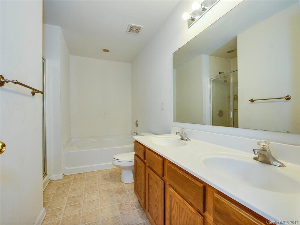 932 Garrison Road Charlotte, NC 28262 - Photo 14 of 20 a bathroom with a sink a toilet and shower