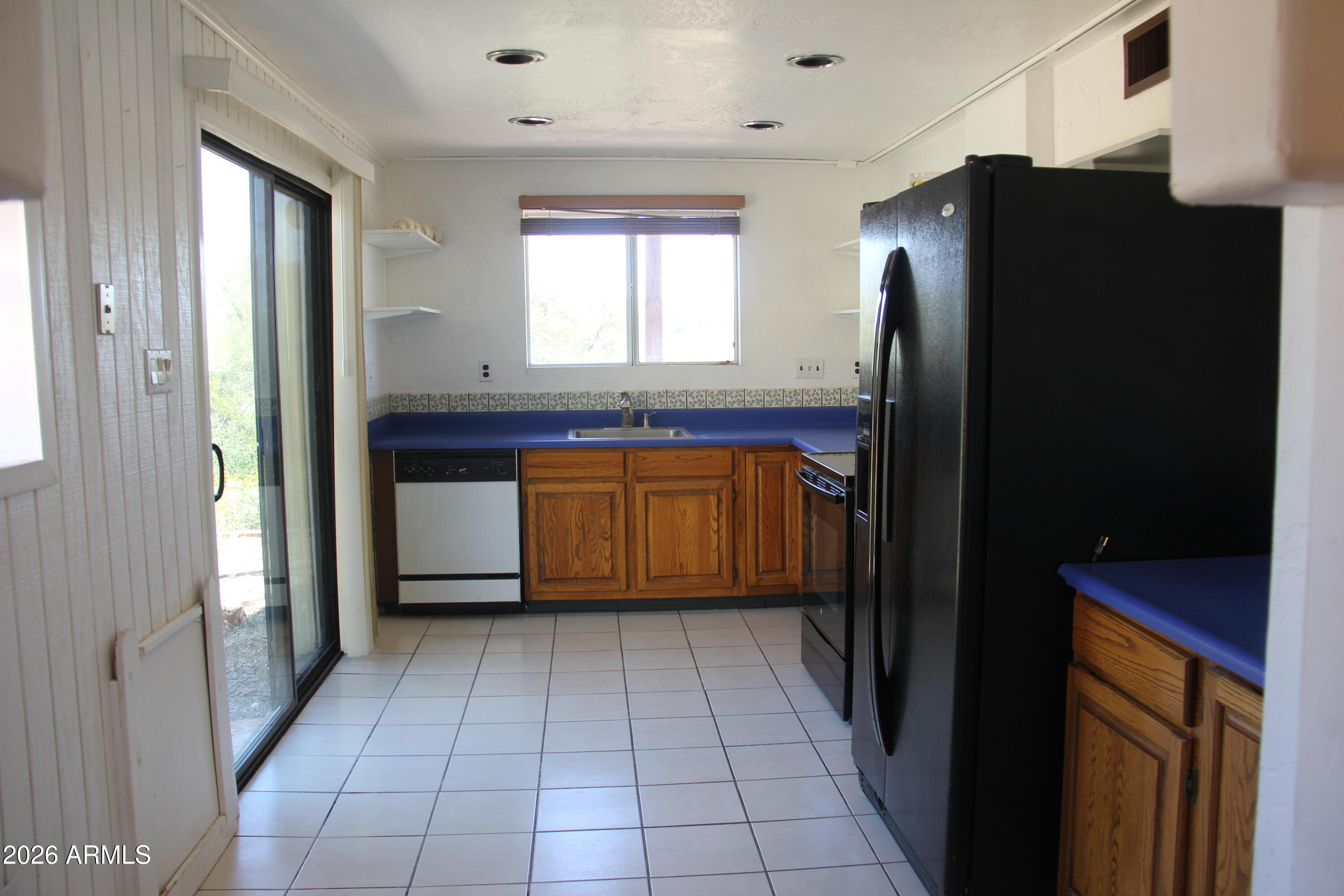 1315 North Arroya Road Apache Junction, AZ 85119 - Photo 11 of 24 a kitchen with stainless steel appliances granite countertop a refrigerator and a sink