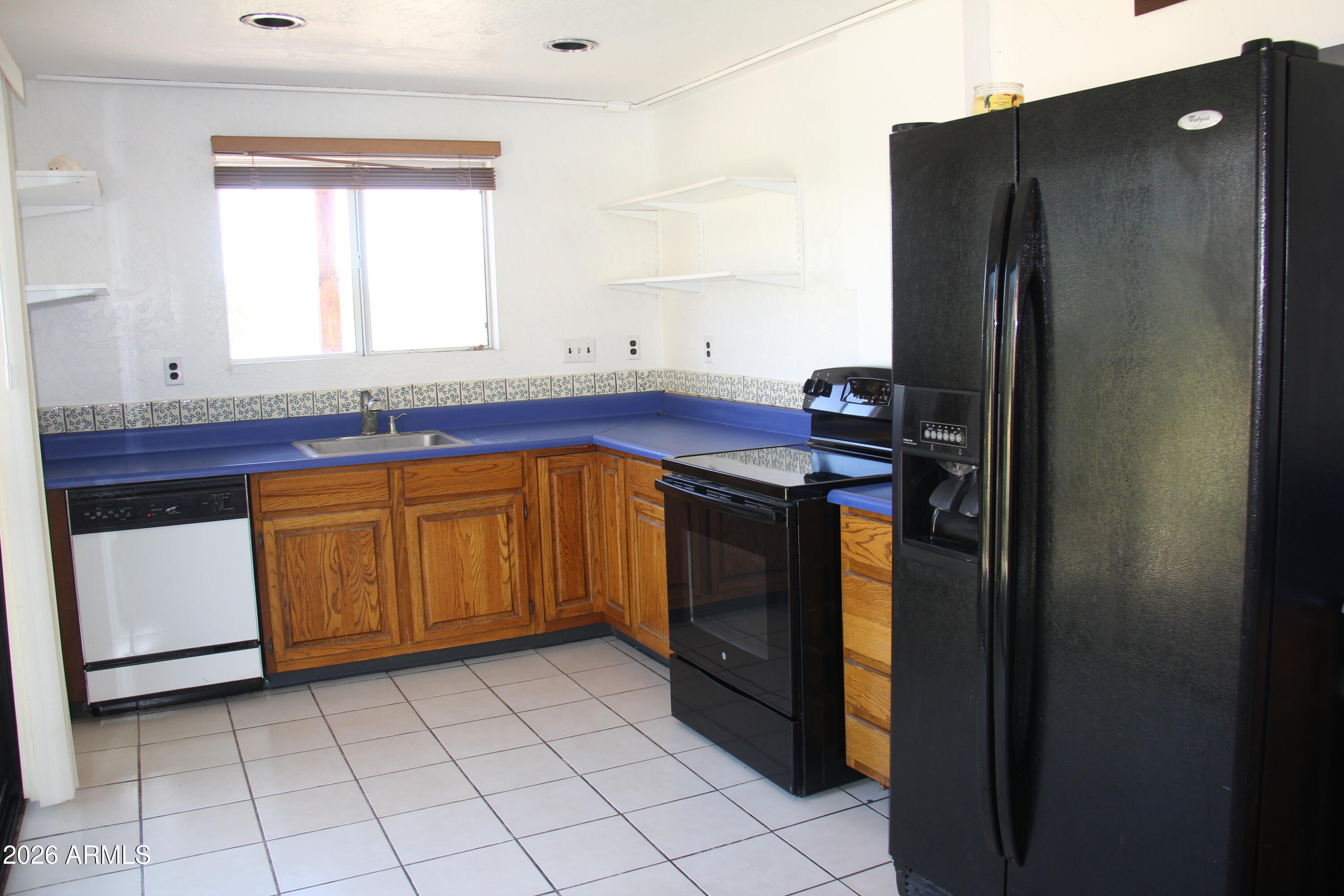 1315 North Arroya Road Apache Junction, AZ 85119 - Photo 12 of 24 a kitchen with stainless steel appliances granite countertop a refrigerator and a sink