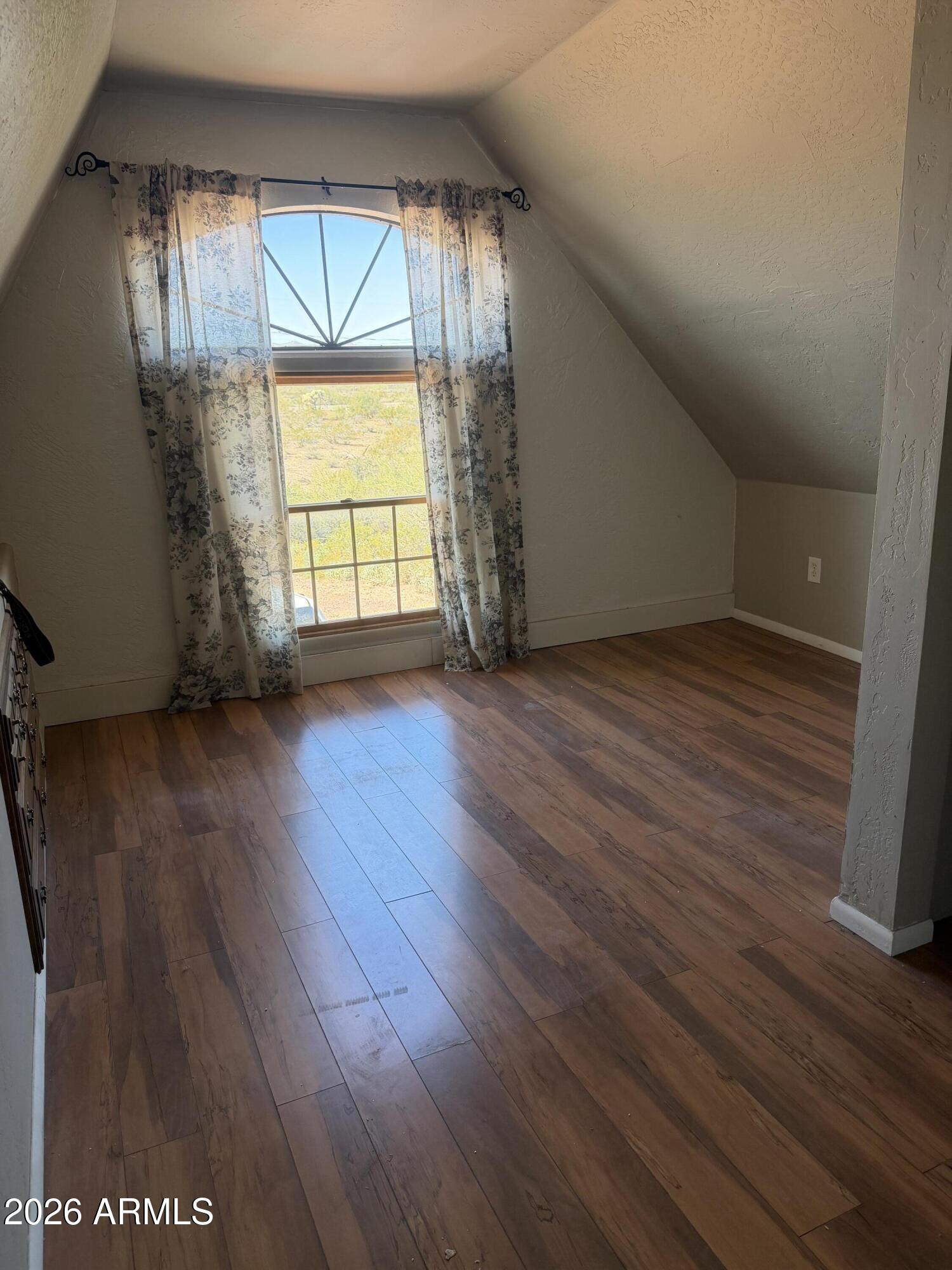 1315 North Arroya Road Apache Junction, AZ 85119 - Photo 16 of 24 an empty room with wooden floor and windows
