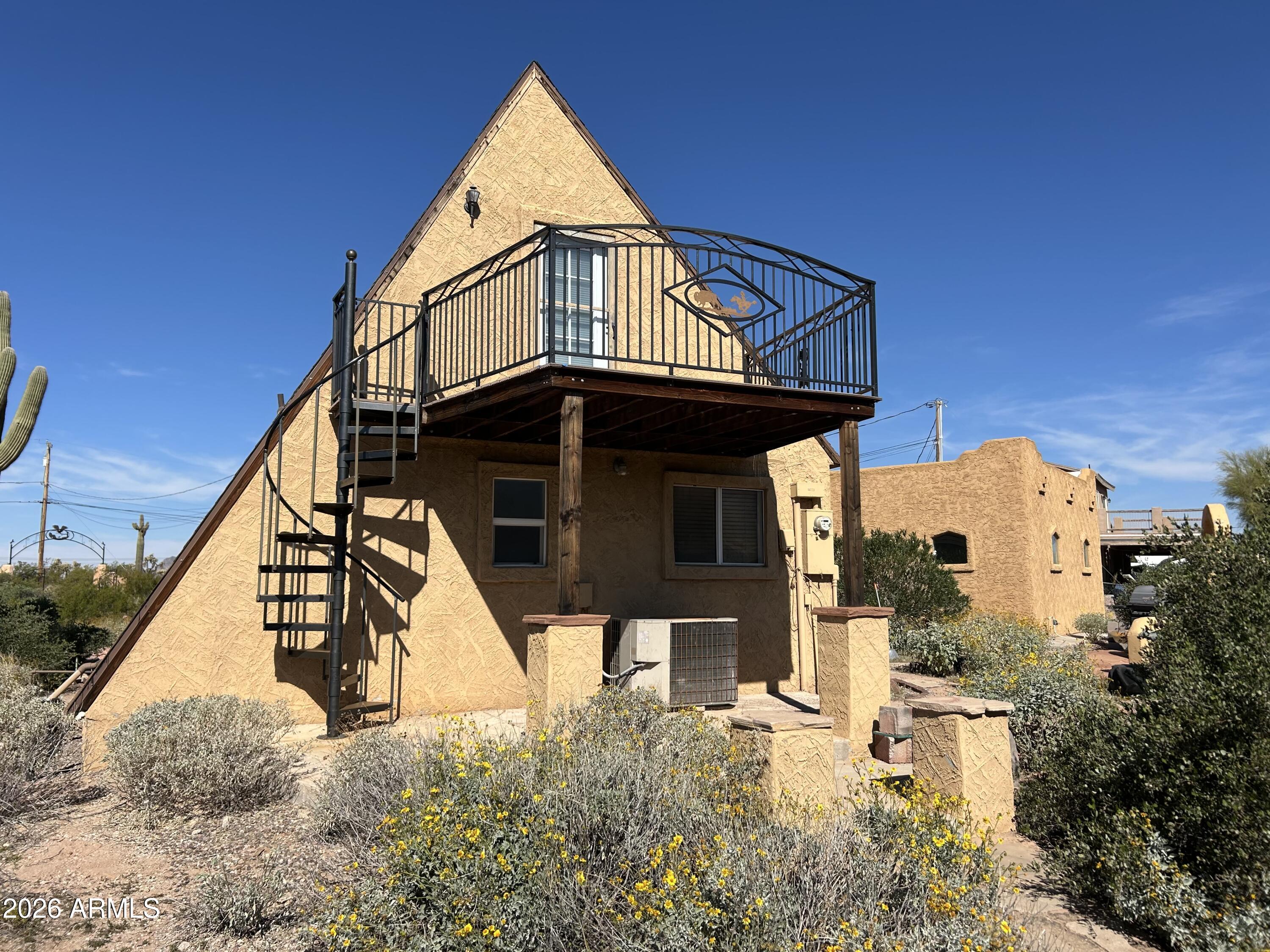 1315 North Arroya Road Apache Junction, AZ 85119 - Photo 6 of 24 front view of a house with a small yard