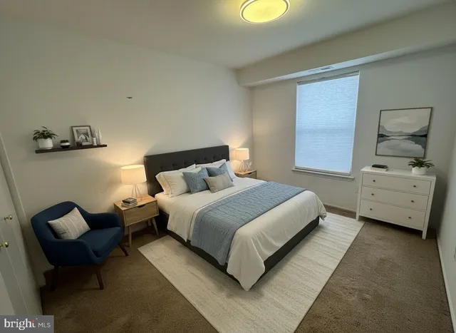 a bedroom with a bed and chair