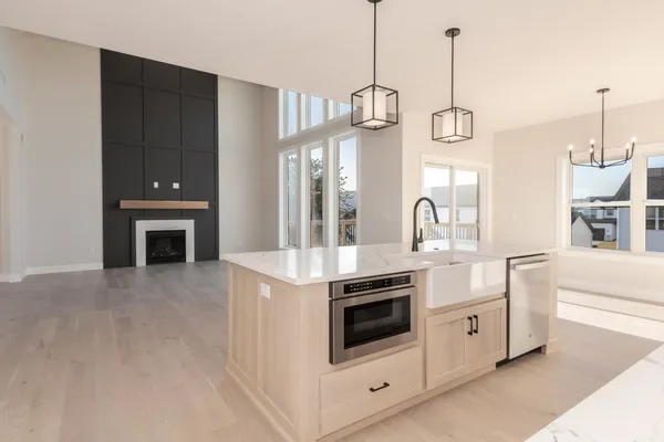 a kitchen with stainless steel appliances granite countertop a stove and a wooden floors